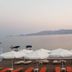 Haraki Mare Studios & Apartments in Rhodes with white umbrellas, orange loungers, and calm sea views