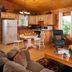 Engadine Inn and Cabins in Candler: cozy cabin suite with stone fireplace, kitchen, and mountain view