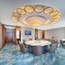 The Greenway Hotel Xiamen meeting room in Xiamen with round table, chairs and ornate ceiling lights