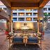 DoubleTree by Hilton Golf Resort Palm Springs courtyard seating area with lit hotel facade in Cathedral City