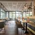 Parkhotel Tjaarda in Oranjewoud restaurant with tables, chairs, and large windows