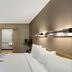 Red Roof Inn Asheville - Biltmore West guest room with bed, desk, TV, and bathroom doorway