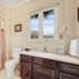 Chateau de Vie Calistoga bathroom with tub-shower, vanity, toilet and window view