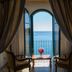 Hotel Lido Mediterranee in Taormina with arched balcony doors framing a sea view and small table