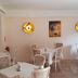 Wald-Hotel Troisdorf dining room with white tablecloth tables and wall-mounted gold lights