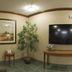 Candlewood Suites Junction City Fort Riley lobby with wall-mounted TV, console table, lamp and potted plant