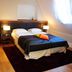 Hotel Zamek Lubliniec room in Lubliniec with a double bed, bedside lamps, wood floors and window light