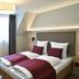 Hotel Restaurant Klosterhof in Gutenzell-Hürbel: double bed with burgundy bedding and window light