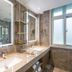 Desheng Hotel Beijing bathroom with double sinks, large mirror, and brass shelving