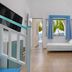 Haraki Mare Studios & Apartments in Rhodes, airy studio with twin beds, sea-view window, and balcony door