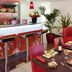 ibis Aulnay Paris Nord Expo bar and lounge with red seating and set dining tables in Aulnay-sous-Bois