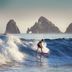 Marquis Los Cabos, Resort & Spa - Adults Only in San José del Cabo with surfer on ocean wave and rocky islets