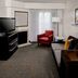 Residence Inn by Marriott Cleveland-Beachwood guest suite with sofa, armchair, TV and floor lamp in Beachwood