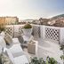 Judita Palace Heritage Hotel rooftop terrace in Split with lounge chairs, table and city views