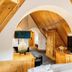 Hotel Riesengebirge in Neuhof an der Zenn attic room with arched wood ceiling and TV
