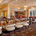 Hilton Garden Inn St. Louis Airport dining room with tables, stools, and bar seating