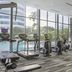 Fraser Suites Singapore fitness center with treadmills, ellipticals and floor-to-ceiling windows in Singapore