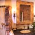 Hazienda Apartmenthotel Gernsbach bathroom vanity with brick accent wall, large mirror, and sink