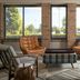 Four Points by Sheraton Milwaukee North Shore lounge with large windows, leather chairs and plaid ottoman in Brown Deer