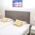 Hotell Linden in Östersund guest room with twin bed, bedside tables, chair and wall art