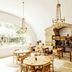 Le Moulin, Lourmarin dining room with arched window and rustic stone fireplace