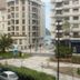 Hotel Zaragoza Plaza in San Sebastian with a palm-lined plaza and partial sea view between city buildings