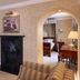 Marygreen Manor Hotel, Brentwood room with fireplace, archway to bedroom and striped sofa