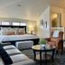 Mccall House Boutique Inn in Ashland guest room with sitting area, bed, and kitchenette