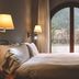 Abba Xalet Suites Hotel in Sispony bedroom with balcony and mountain view through arched doors