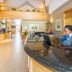 Town Lodge Menlo Park in Pretoria reception desk with staff member behind a curved counter