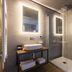 Antico Borgo di Sutri bathroom with vessel sink, glass shower, and illuminated mirror in Sutri