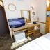 Toyoko Inn Kofu eki Minami guchi No 1 room with bed, desk, TV and mirror in Kōfu