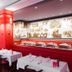 Best Western Hotel De France in Bourg-en-Bresse restaurant with red walls and white tablecloths