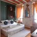 Les Monges Palace Boutique in Alicante: cozy guest room with stone wall, twin windows and ornate mirror