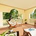 Diamonds Malindi terrace with lounge chairs, dining table and tropical garden views in Malindi