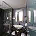 City Hotel Dresden Radebeul bathroom with glass shower, vessel sink, and modern mirror in Radebeul