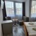 Hotel Icon Győr guest room with twin beds, seating area, and large windows