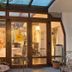 Hotel City Pisek in Písek entrance with glass doors, patio seating, and a covered entryway