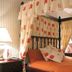 Britannia Stockport Hotel bedroom with four-poster bed and orange bedding in Stockport
