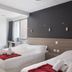Lille City Hotel in Lille guest room with two single beds, bathroom doorway, and window view