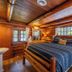 Copper Creek Inn, Cabins and Lodge cabin bedroom with log walls and wood-beam ceiling in Ashford