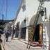 Mar de Cortez in Cabo San Lucas exterior with arched storefronts and ladders leaning against the building