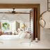 Paradise Cove Boutique Hotel, Cap Malheureux: dual sink vanity opening to a canopy bed and ocean-view balcony