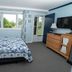 Governor's Rock Motel in Shaftsbury: guest room with quilted bed, window view, TV and dresser