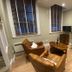 The Old Railway Station in Petworth lounge with leather chairs, brick fireplace and wood floors