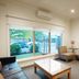 The Wyndhamere Motel Shepparton lobby with seating area, coffee table, wall TV, and large window view.