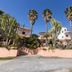 Residence Esmeraldo in Capo Vaticano with palm trees, cactus landscaping, and a white hotel building