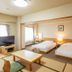 Hotel Sunplaza Sakai in Sakai guest room with two beds, TV, and low table