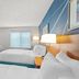 Comfort Inn & Suites Berea guest room with two beds, TV, desk, and window view