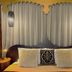 The Retreat at Froog Moore Park in Tamworth bedroom with canopy bed, sheer curtains and pendant lights